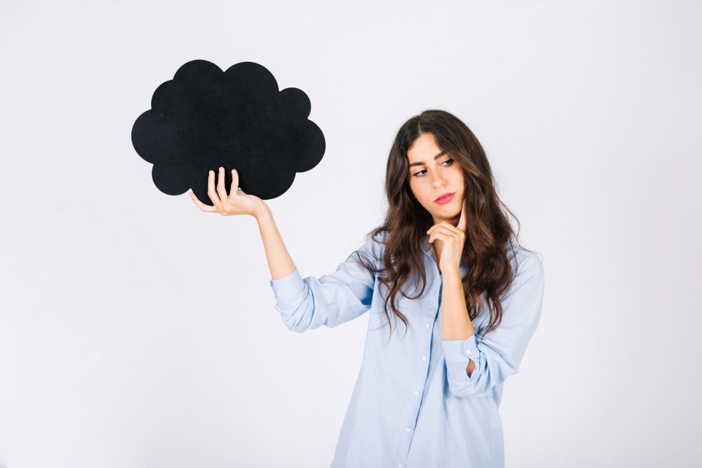 A woman holding up her dreams and thinking.