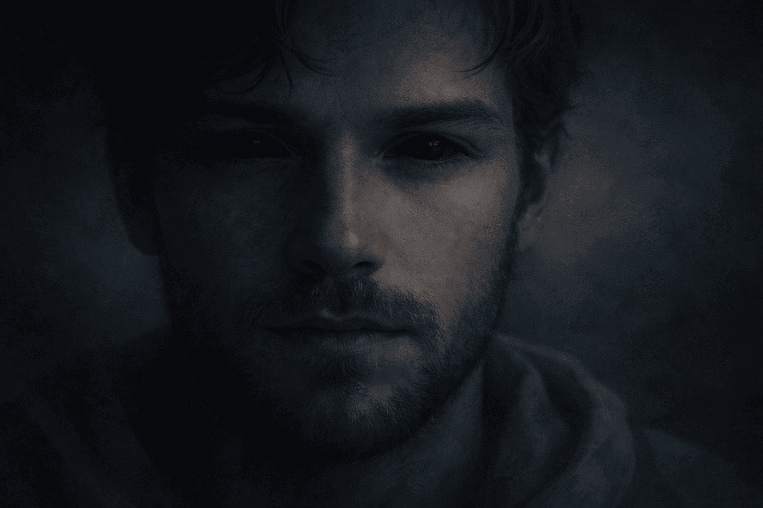 Calm male face in soft darkness with fully black eyes, blue tones, symbolic biblical dream imagery