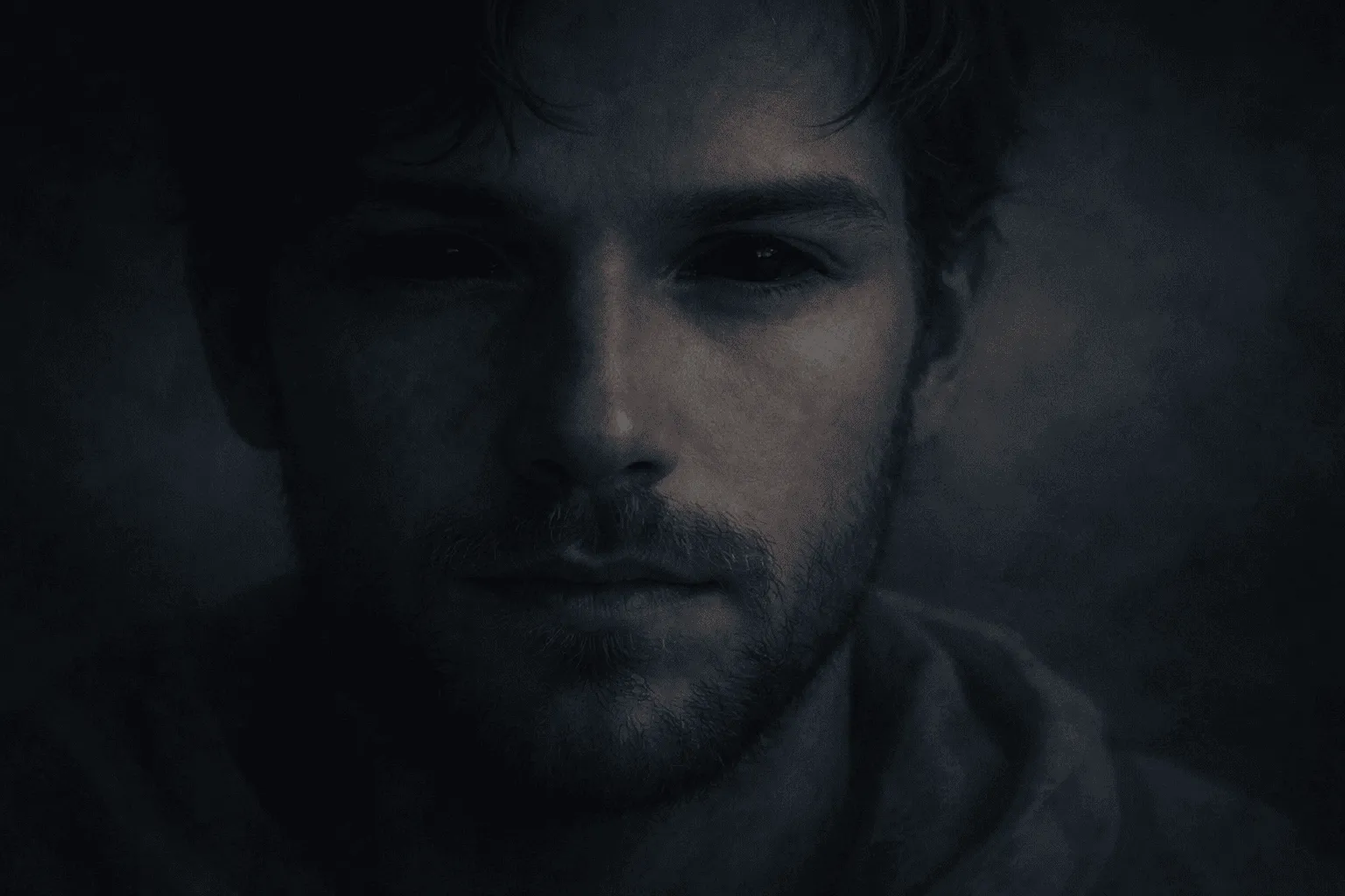 Calm male face in soft darkness with fully black eyes, blue tones, symbolic biblical dream imagery
