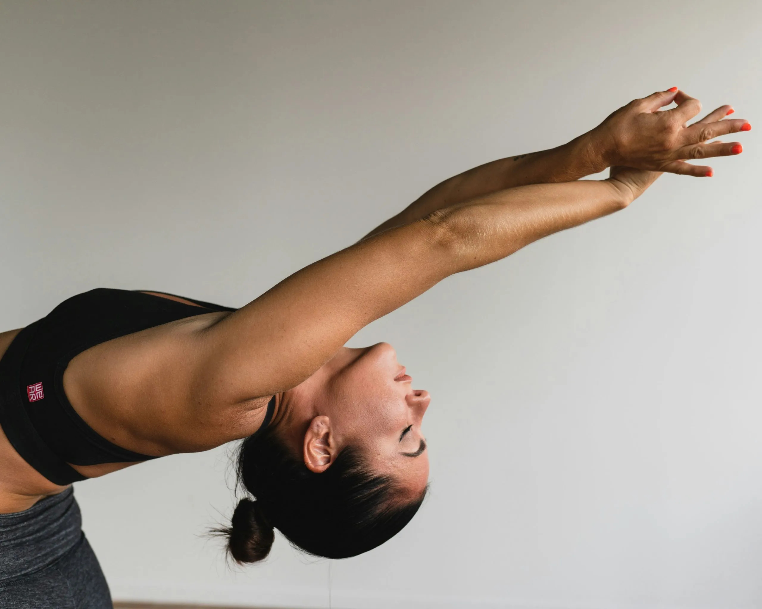 Woman stretching in a yoga pose, symbolizing relaxation, body awareness, and mental clarity