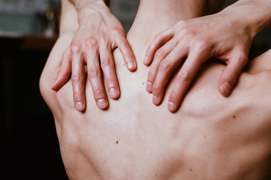 A man touching his back | Image Source: Pexels