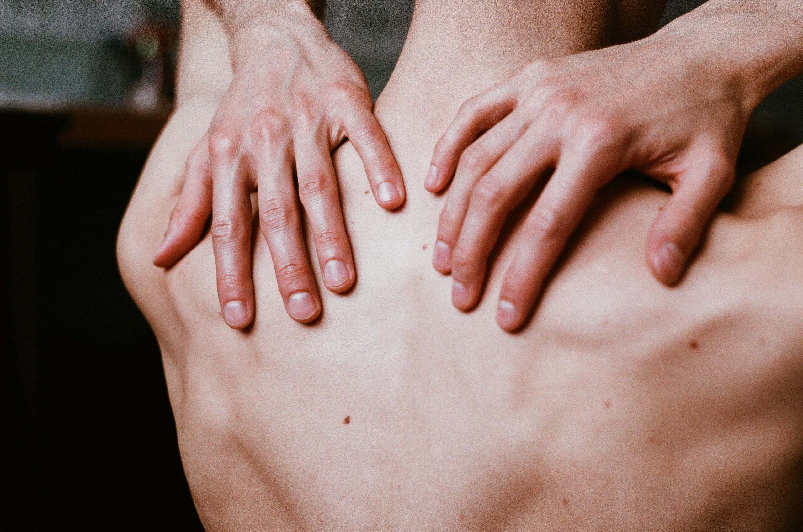 A man touching his back | Image Source: Pexels