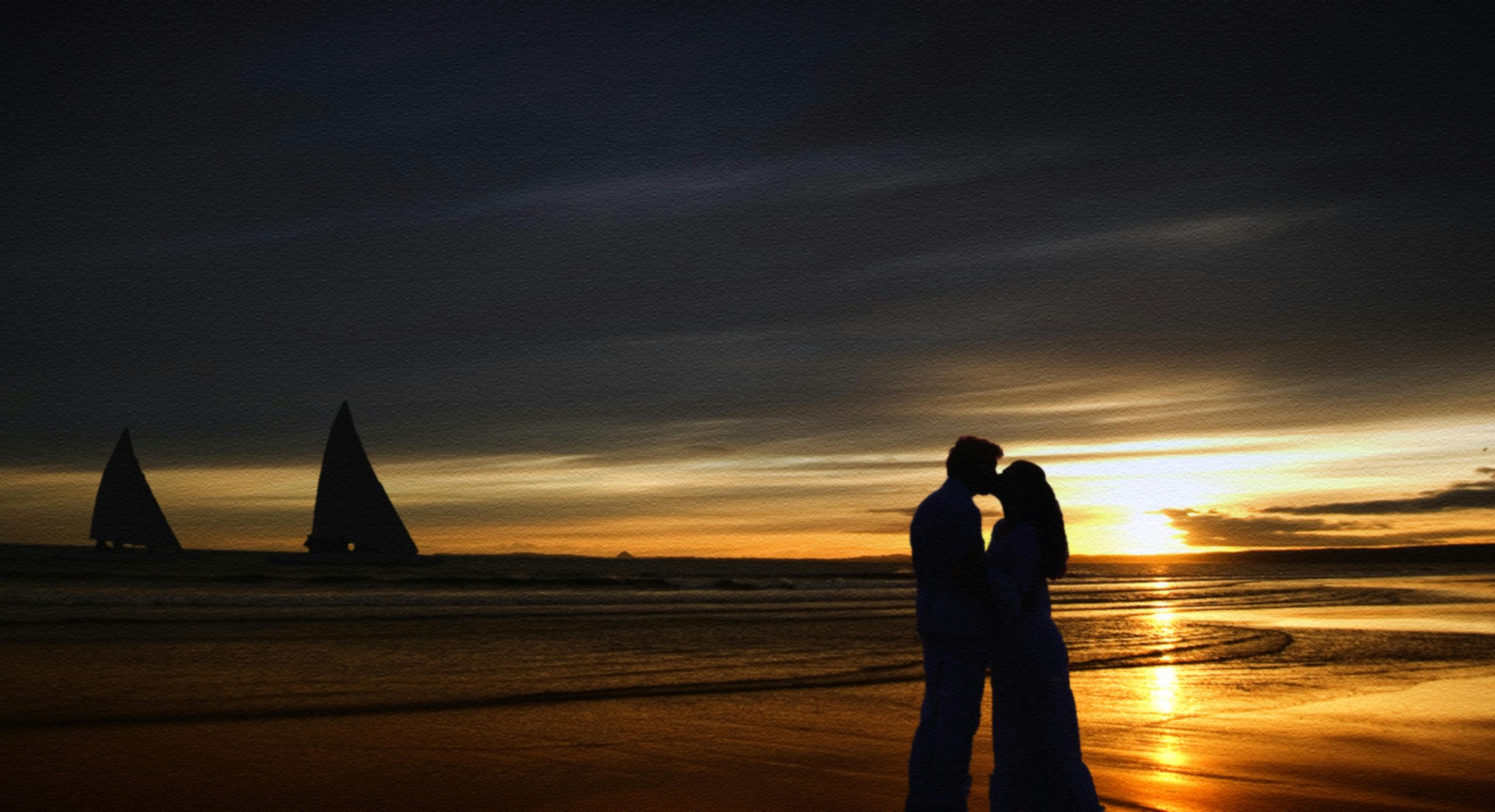 A couple kissing on the beach | Image Source: Pexels