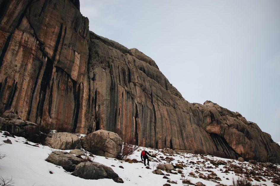 A huge mountain range in front of a man | Image Source: Pexels