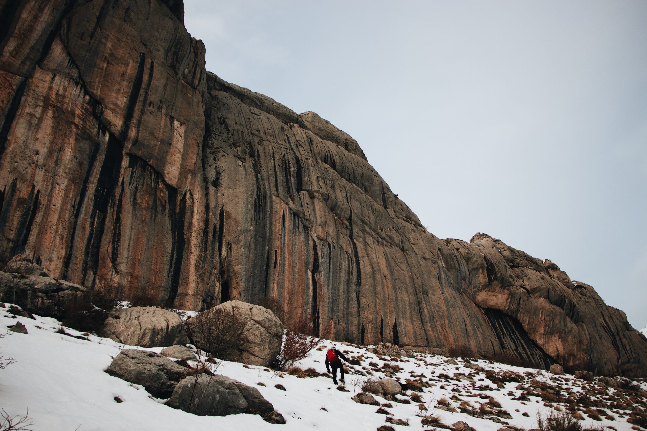 A huge mountain range in front of a man | Image Source: Pexels